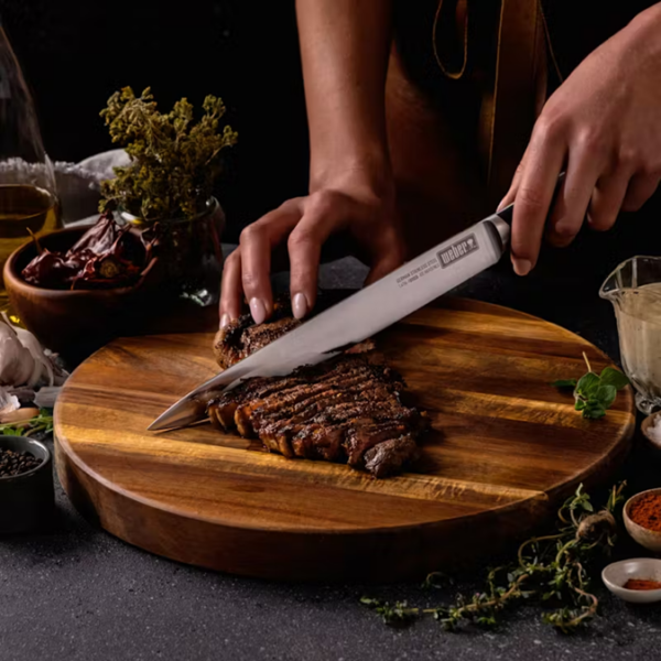 German steel cold forged Carving knife slicing a steak.